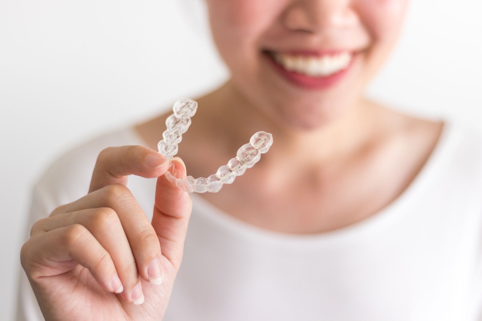 woman holding invisalign braces in South Surrey at Rosemary Heights Dental