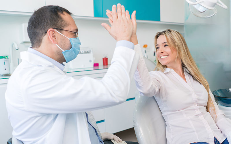 Dentist pointing at dental implant consulting patient in Surrey Dental Centre